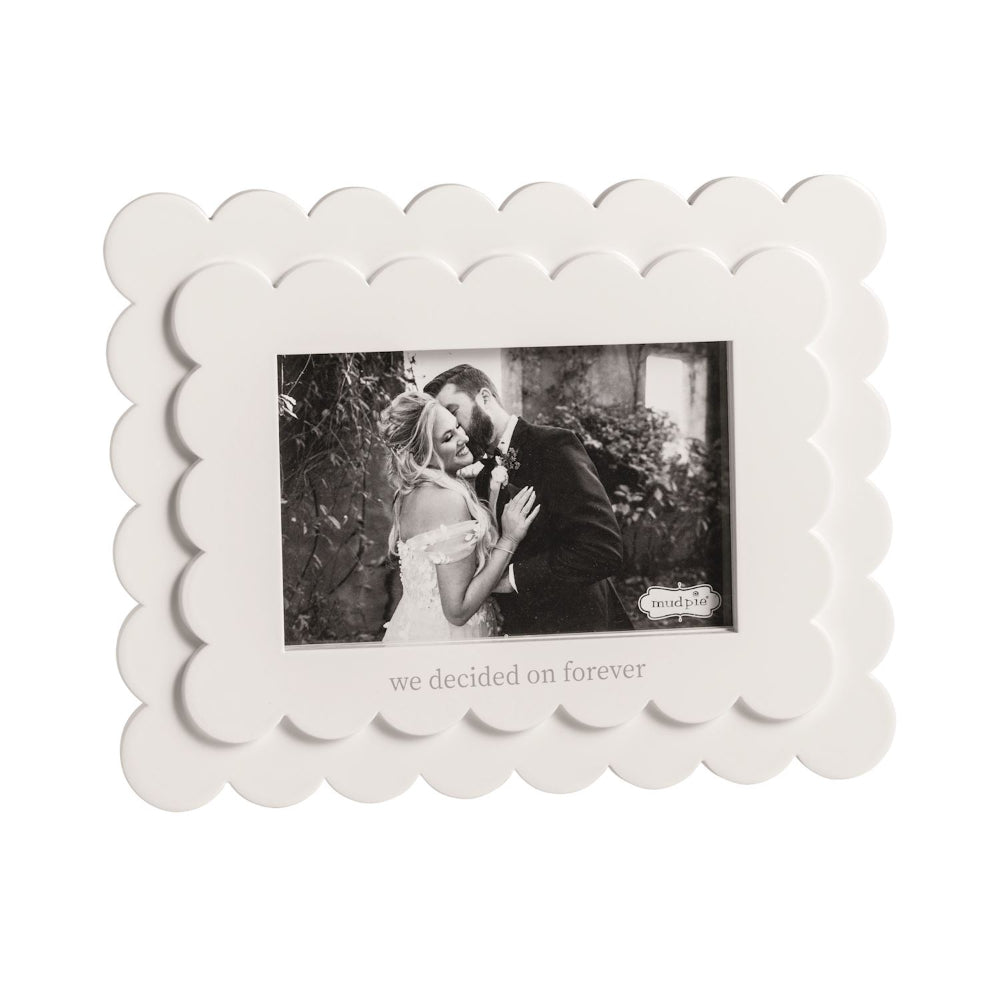 White scalloped photo frame with a black and white photo of a couple and text 'we decided on forever' on a white backround. 