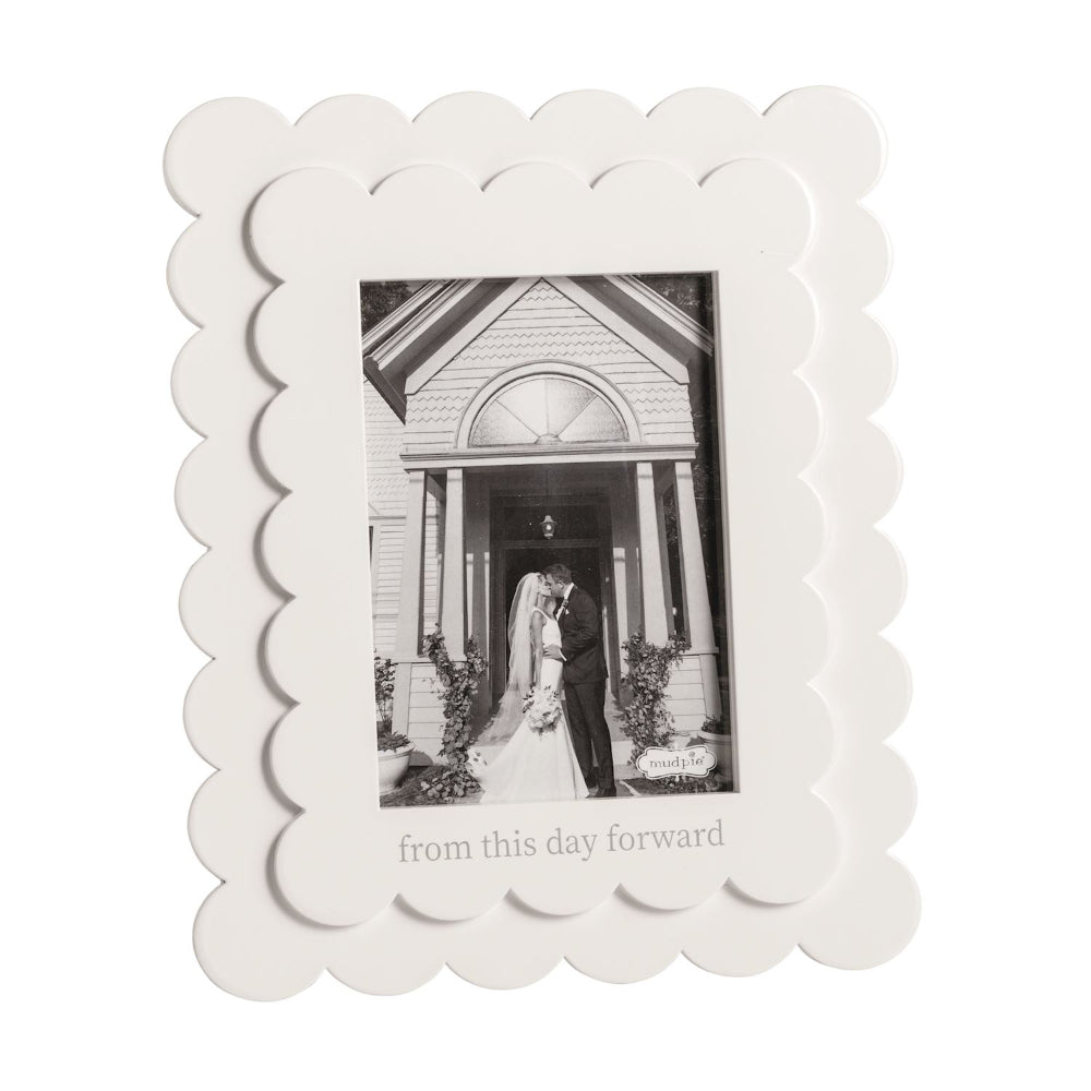 White scalloped photo frame with a black and white photo of a couple and 'from this day forward' text on a white backround.