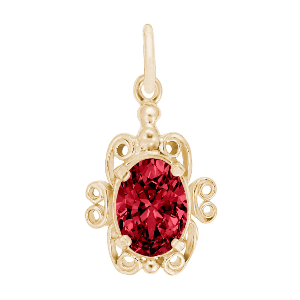 Gold pendant with a red gemstone on a white background