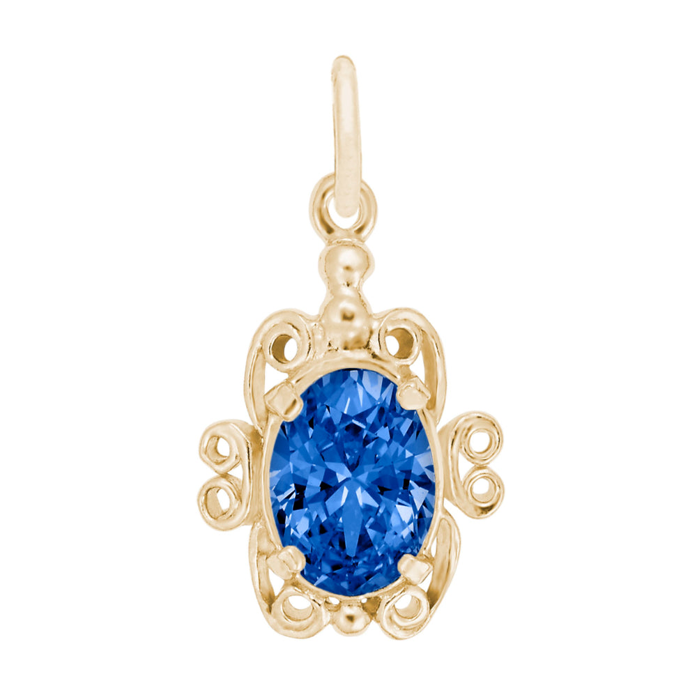 Gold pendant with a blue gemstone on a white background