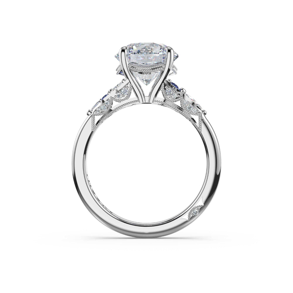 A high-end diamond engagement ring in a polished white gold or platinum setting, featuring a large round brilliant-cut center stone and smaller diamonds along the shoulders, shown on a clean white background.