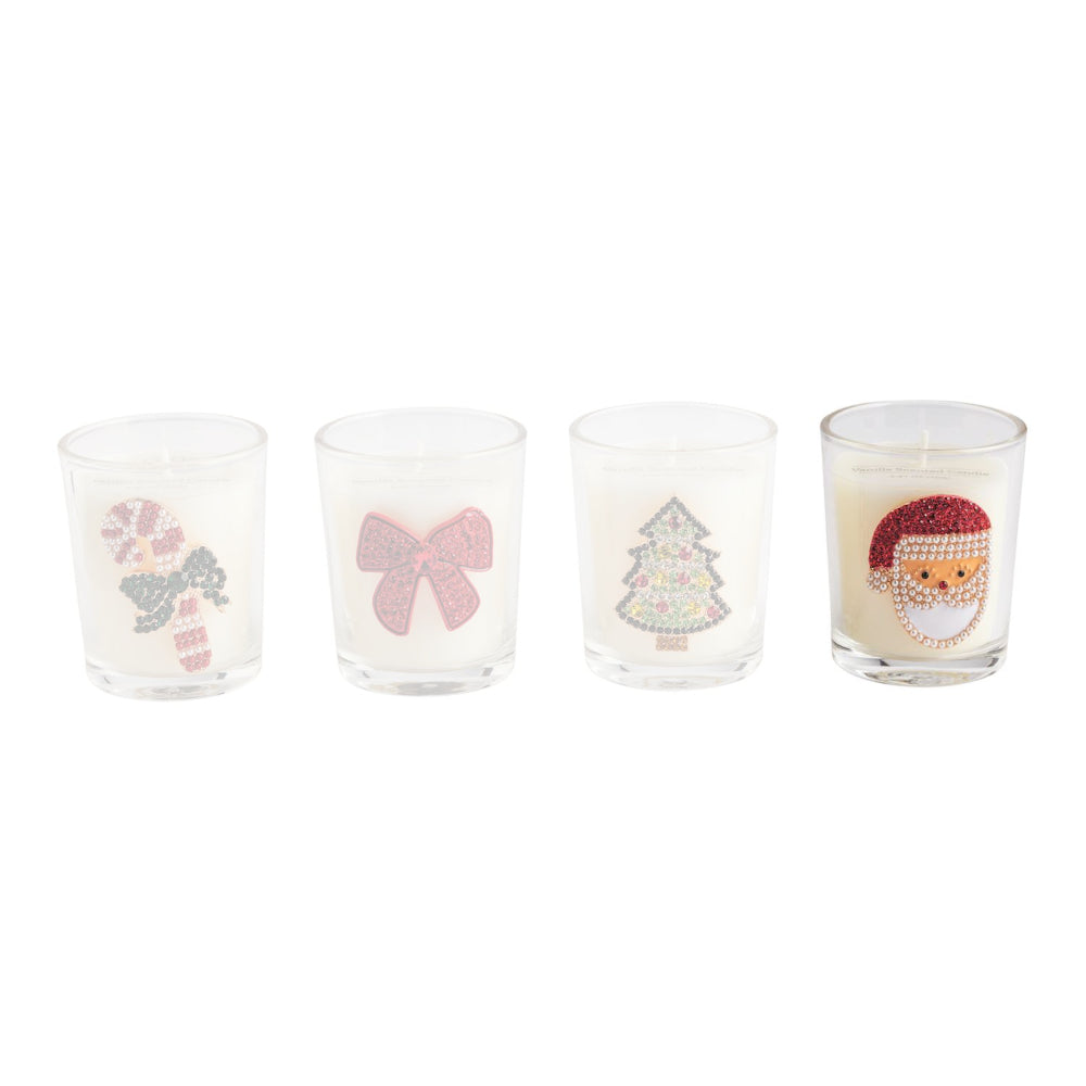 Four small clear glass candle holders with white wax and festive rhinestone decorations, including a candy cane, pink bow, Christmas tree, and Santa face, on a white background.