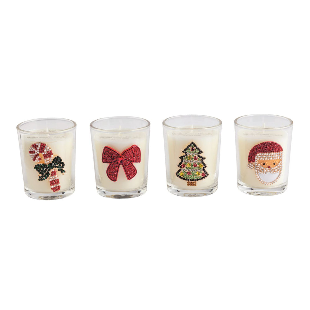 Four Christmas-themed candles in glass holders on a white background