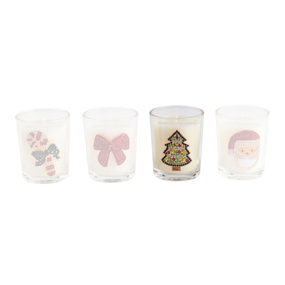Four clear glass candle holders with white wax and festive holiday designs, including a candy cane, pink bow, Christmas tree, and Santa face, arranged in a row on a white background.