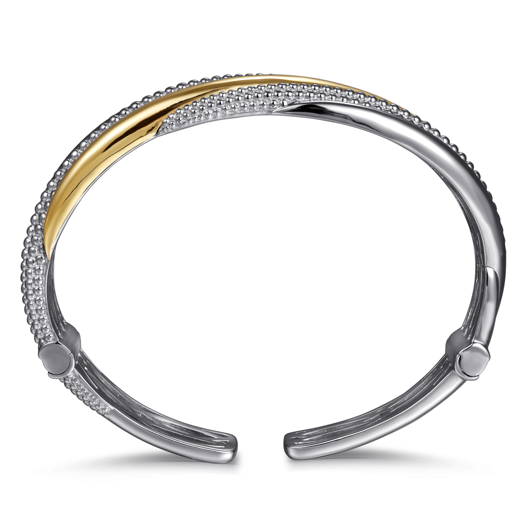 Two-toned bracelet with gold and silver sections on a white background