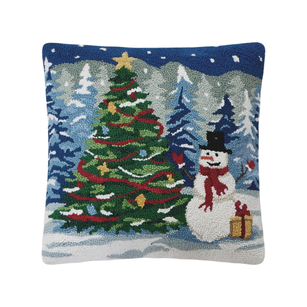 Decorative pillow with a Christmas tree and snowman design on a blue background