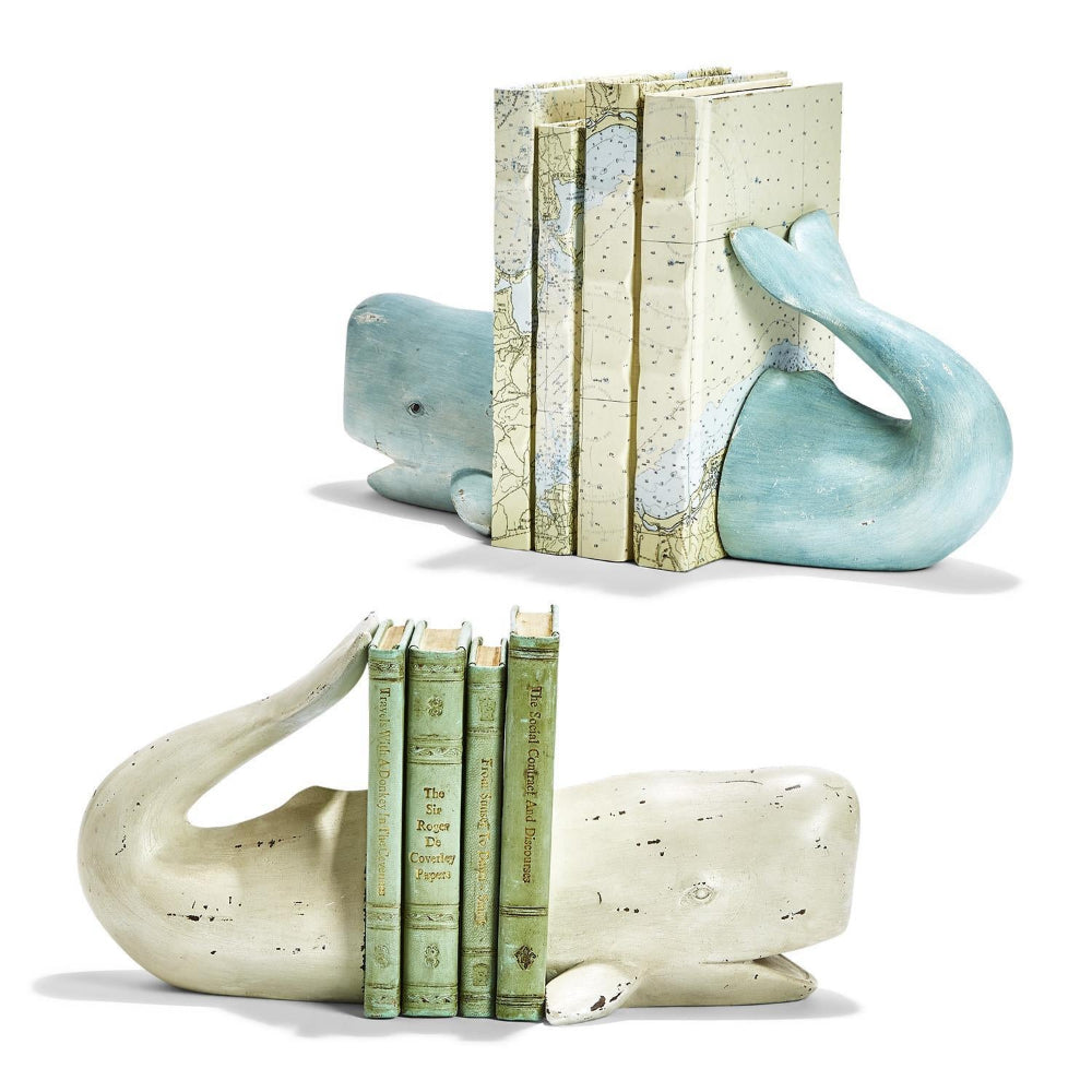 Two aqua and white whale-shaped bookends holding books on a white background.