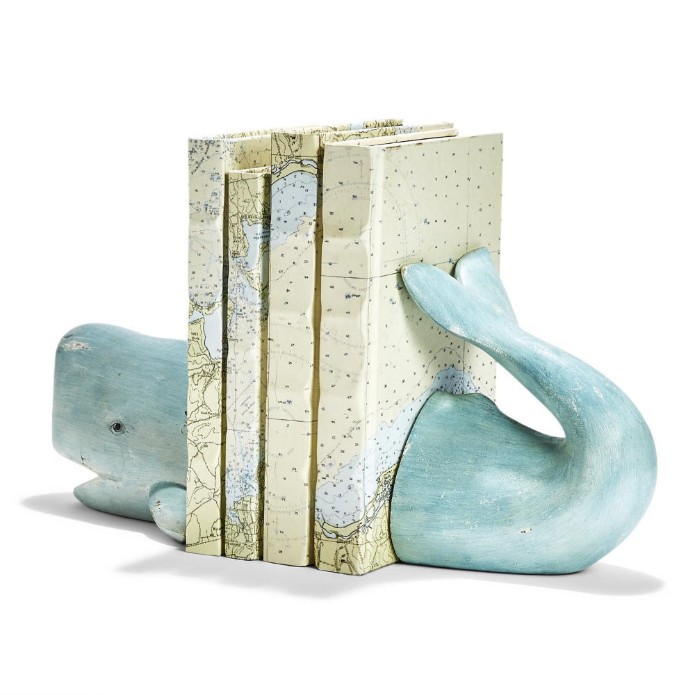 Aqua whale-shaped bookend with a map design on a white background.