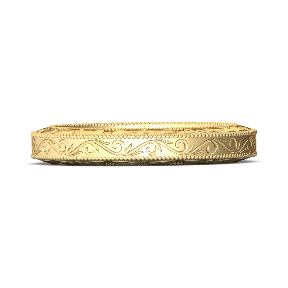 Gold ring with intricate design on a white background