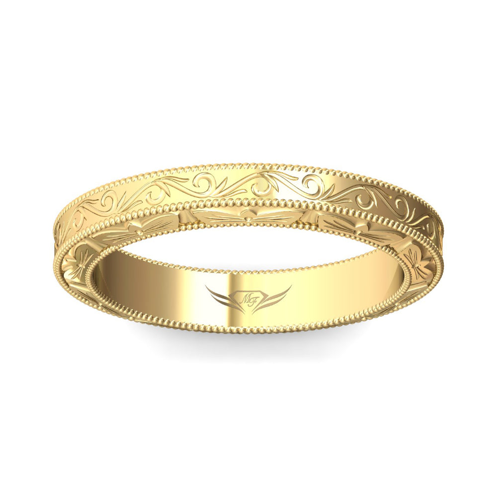 Gold ring with intricate design on a white background