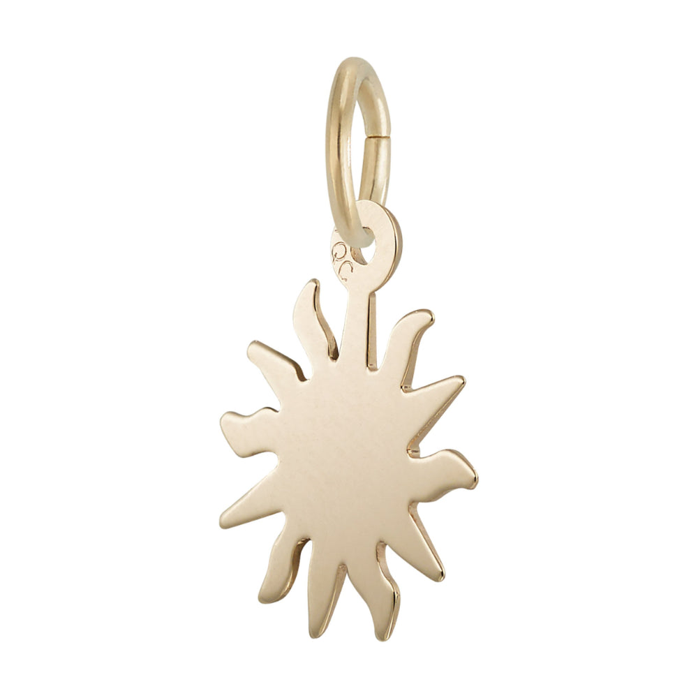 Gold sun-shaped pendant on a white background