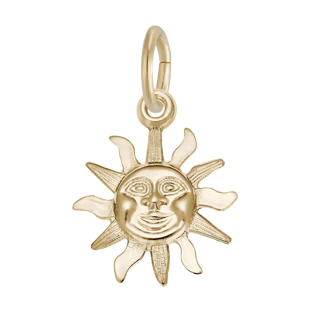Gold sun-shaped pendant with face design on a white background
