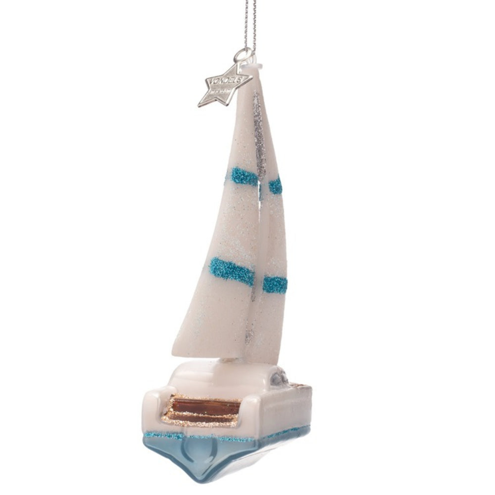 Decorative sailboat ornament with a white sail and blue accents on a white background
