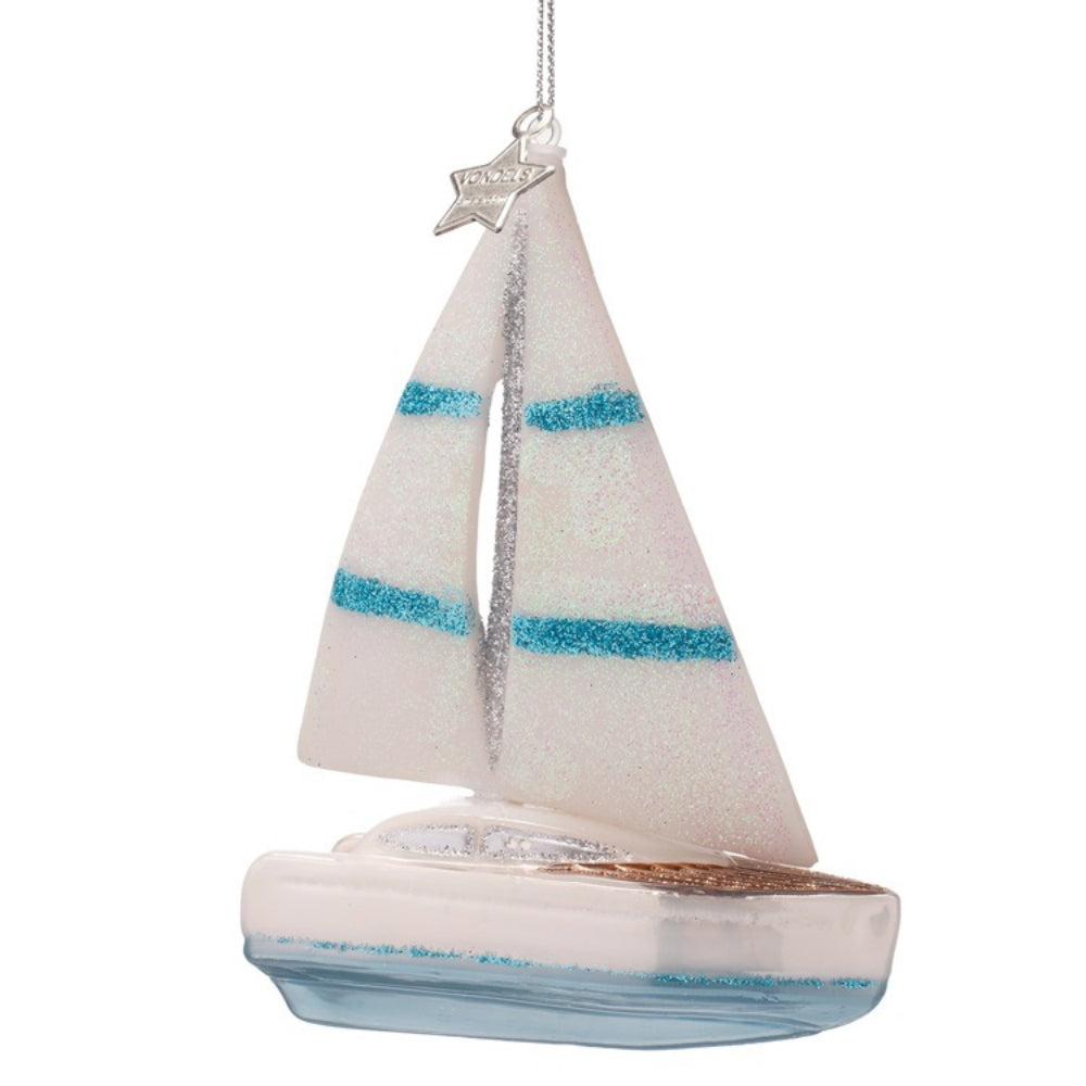 Decorative sailboat ornament with striped sails on a white background