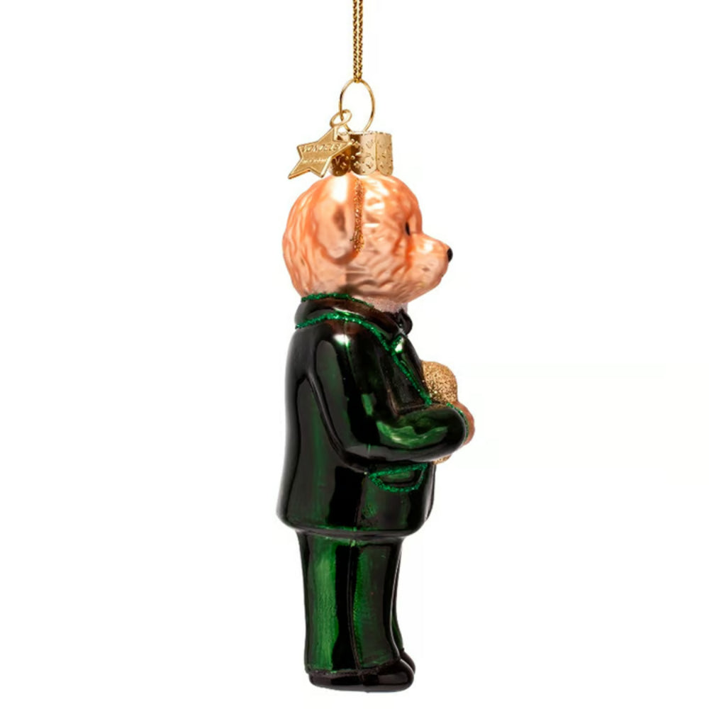 Glass bear ornament wearing a green outfit on a white background