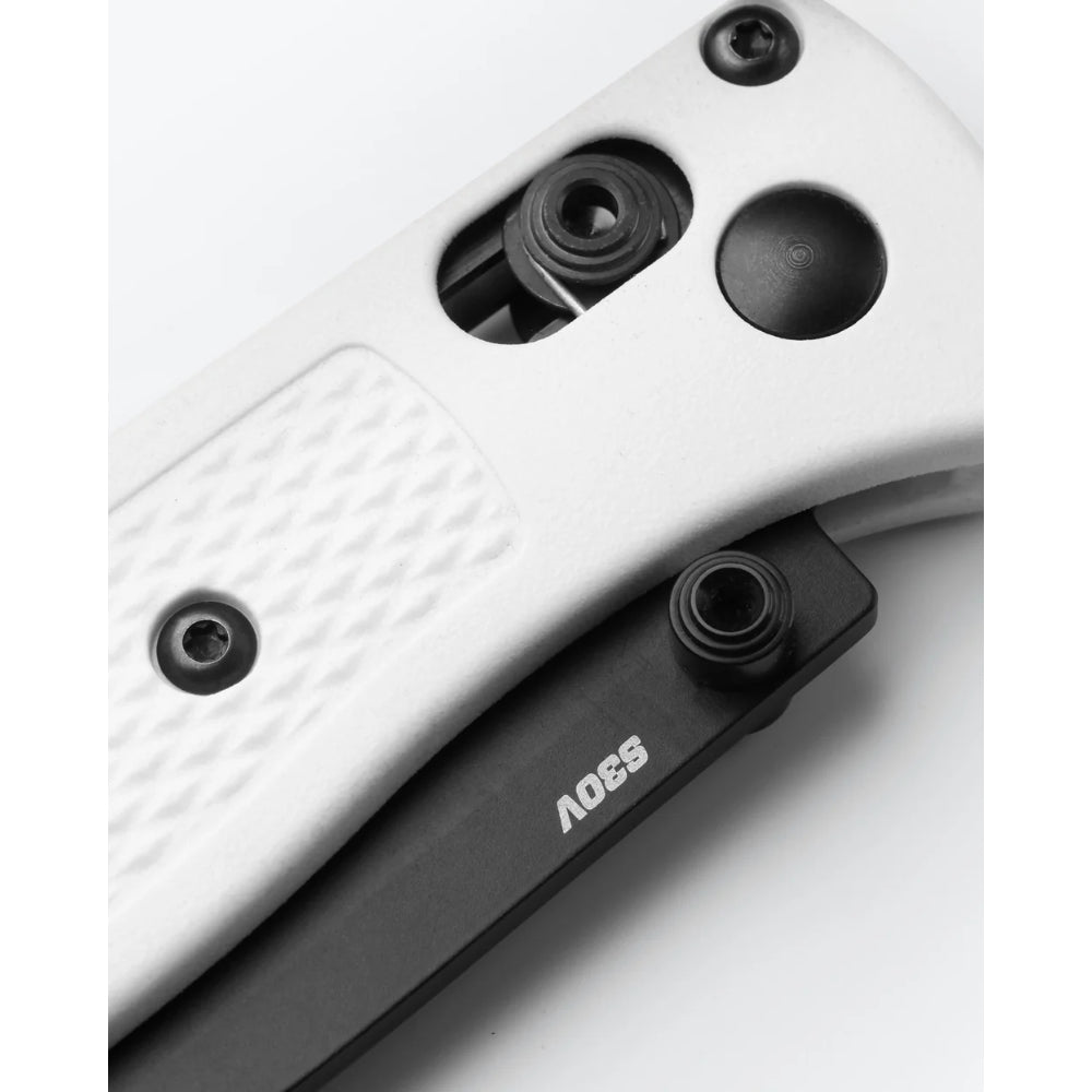 Close-up of a folding knife handle showing a white textured G10 endplate, black hardware, and a black inner liner with the brand name 'SSOV' printed in white.