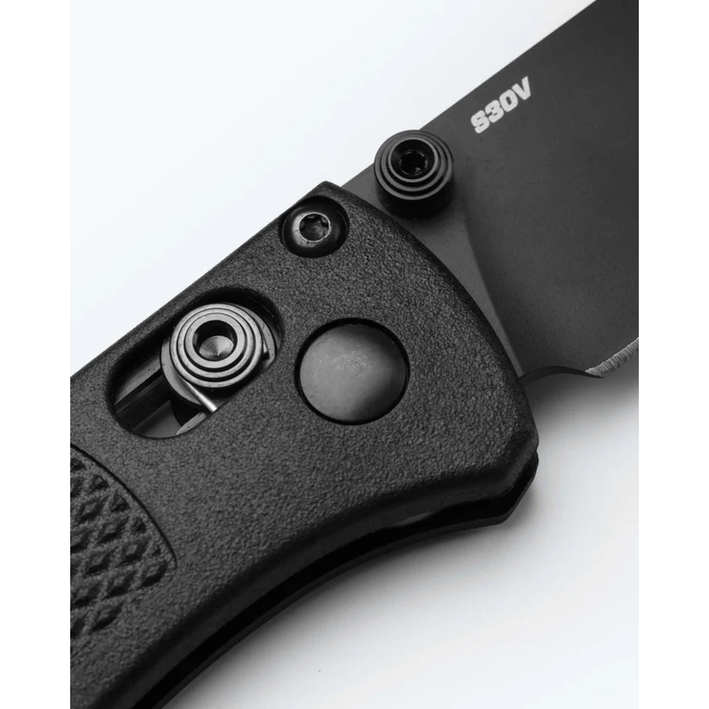 Close-up of a black folding knife handle and partially visible blade with the brand name 'S30V' printed on the metal, shown against a plain white background.
