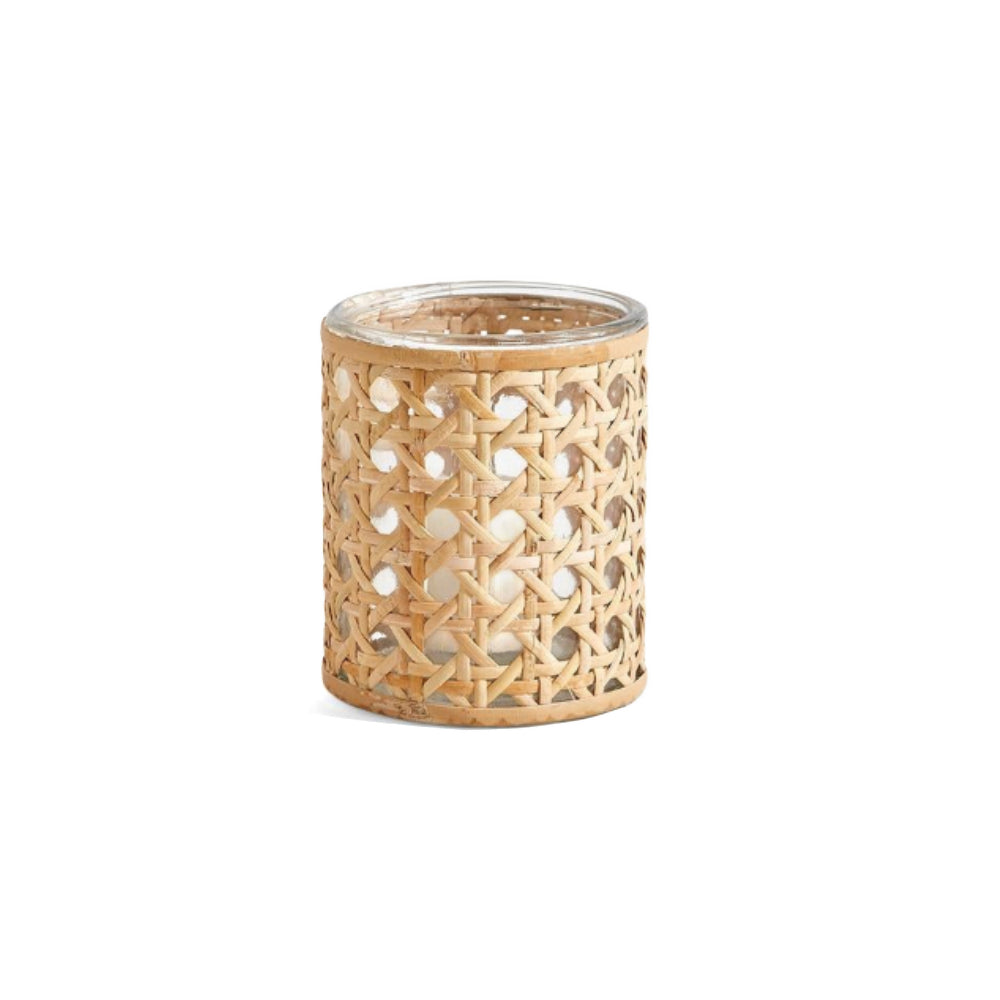 A small cylindrical woven candle holder or lantern made of natural tan wicker with a clear glass top, shown on a plain white background.
