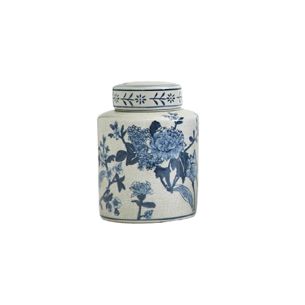 A small cylindrical ceramic tea canister with a matching lid, decorated with a classic blue and white floral pattern on a textured off-white glaze, set against a plain white background.