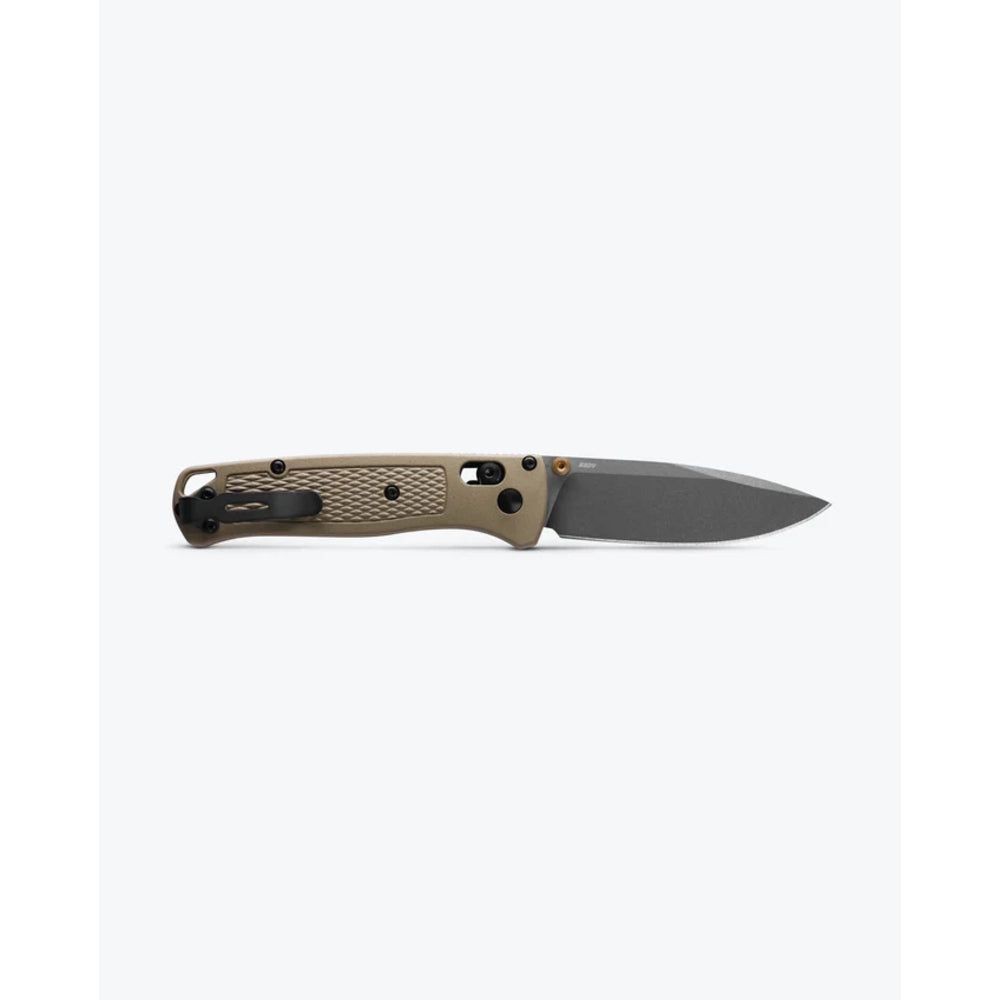 Folding knife with a green handle and black blade on a white background