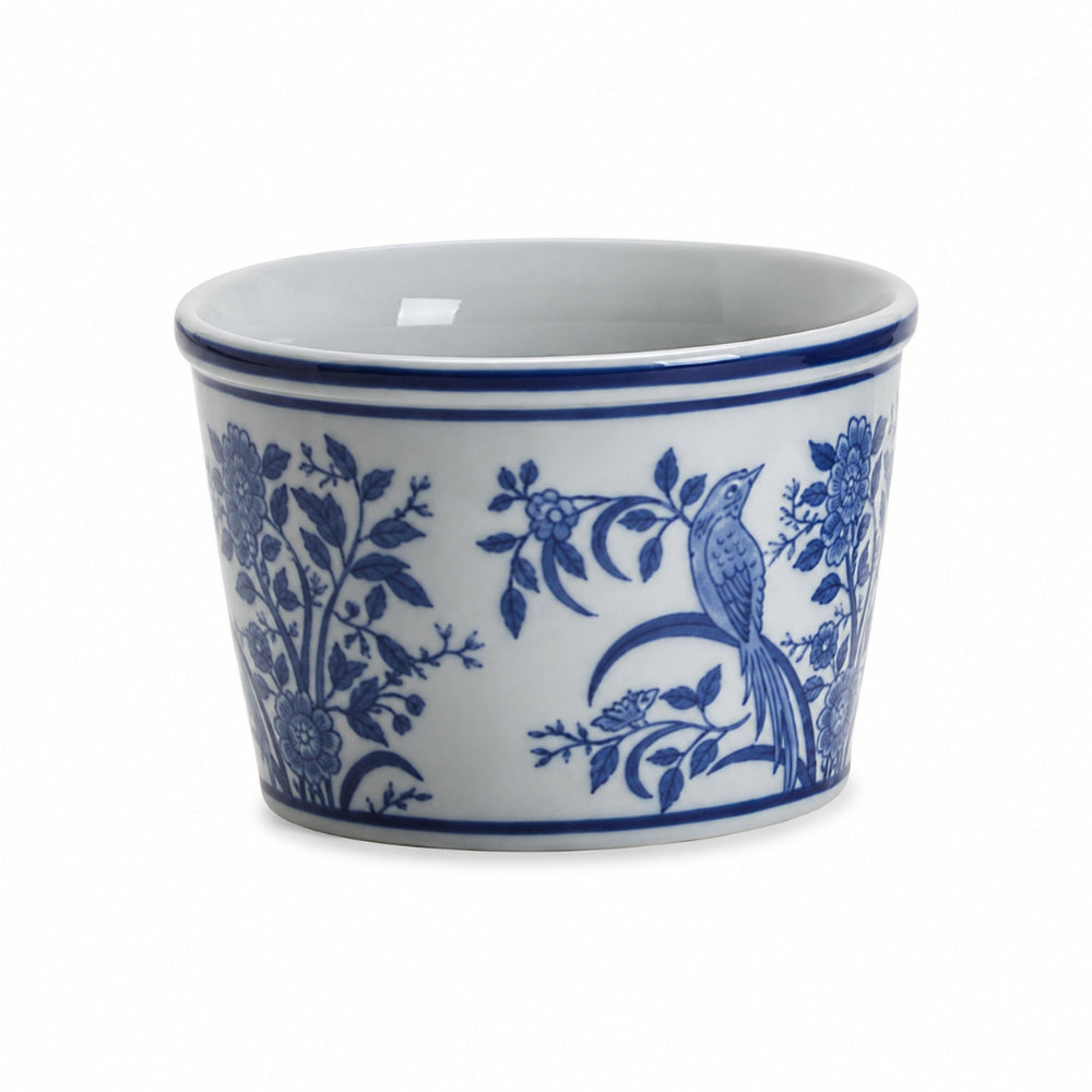 A white ceramic ramekin with a blue floral and bird pattern, photographed on a clean white background.