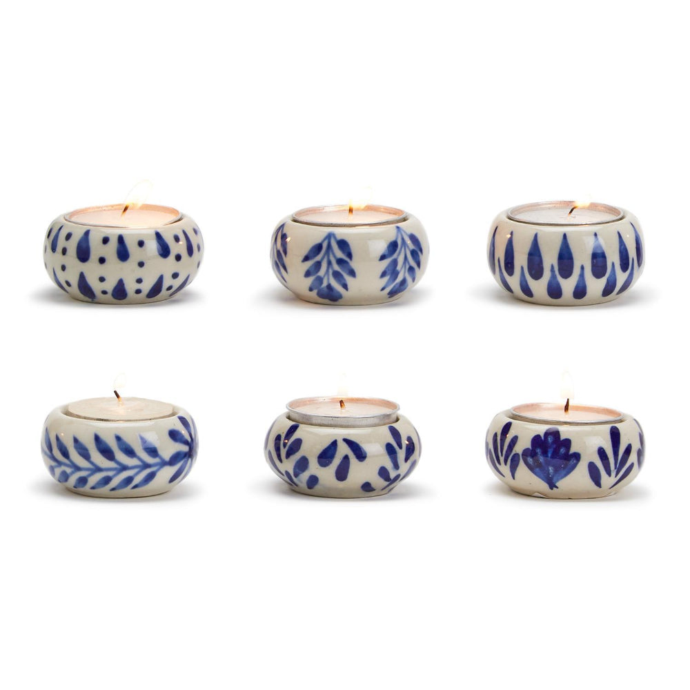 Set of six ceramic tea light holders with blue floral patterns on a white background