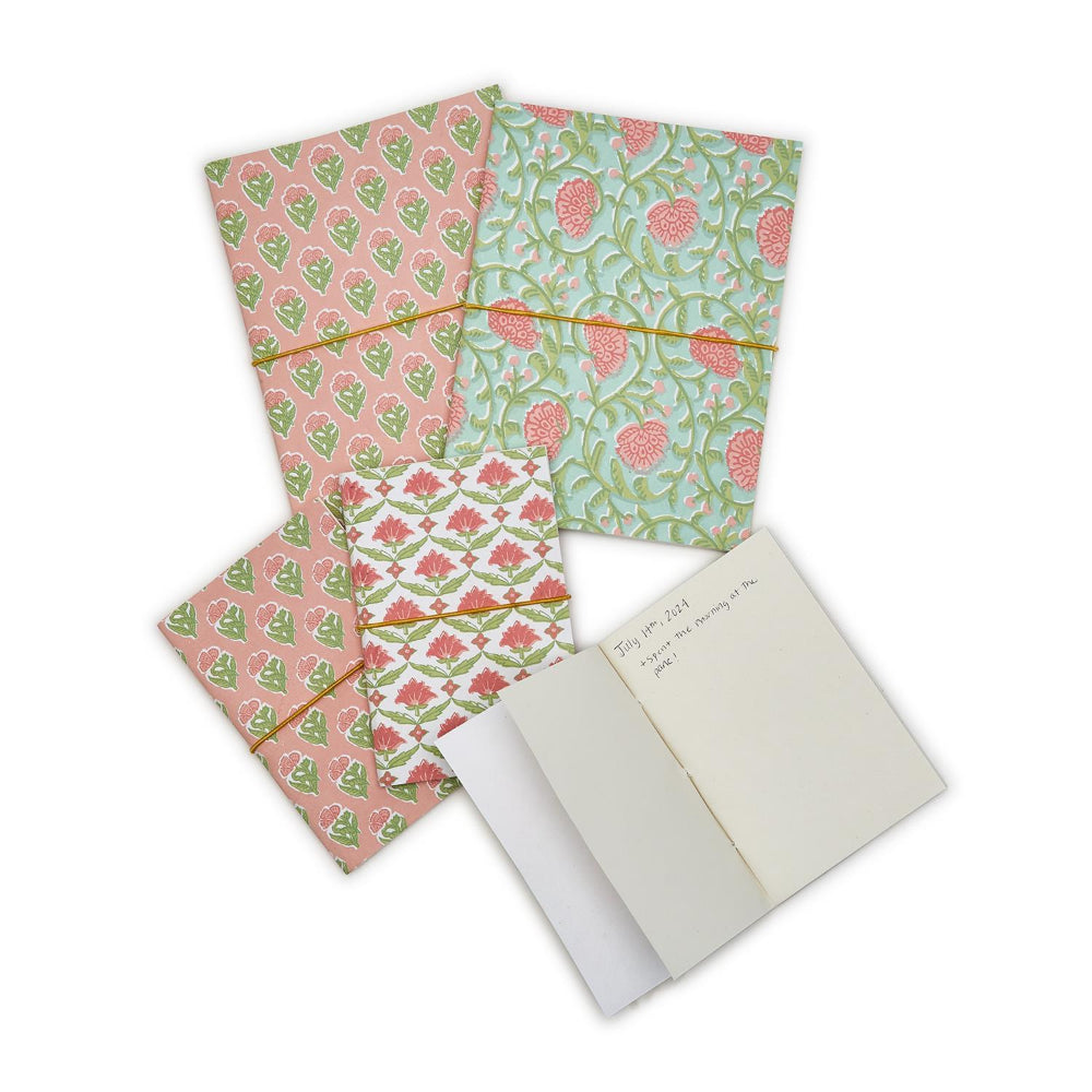 Large & small notebooks with a matching elastic band, displayed alongside an open notebook on a plain white background.
