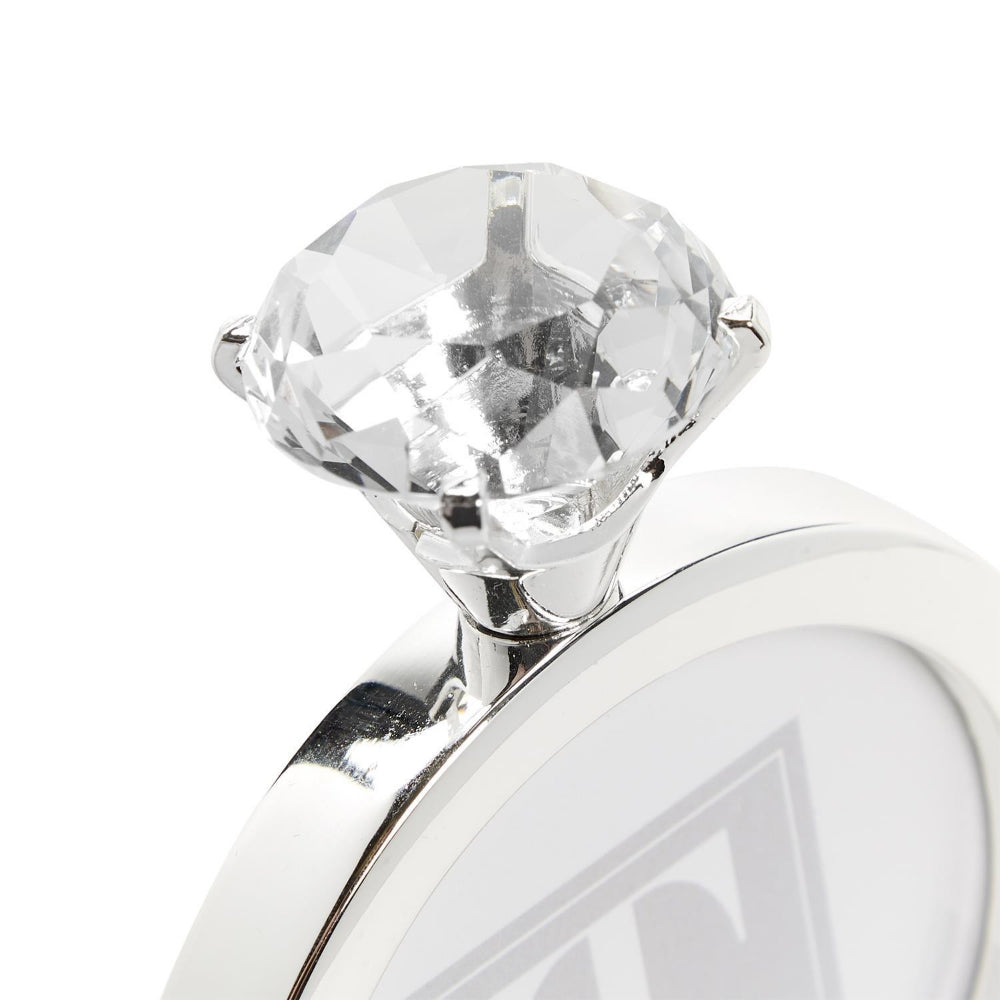 Top of a silver 3"x 3"  diamond ring frame showing the diamond on top. 