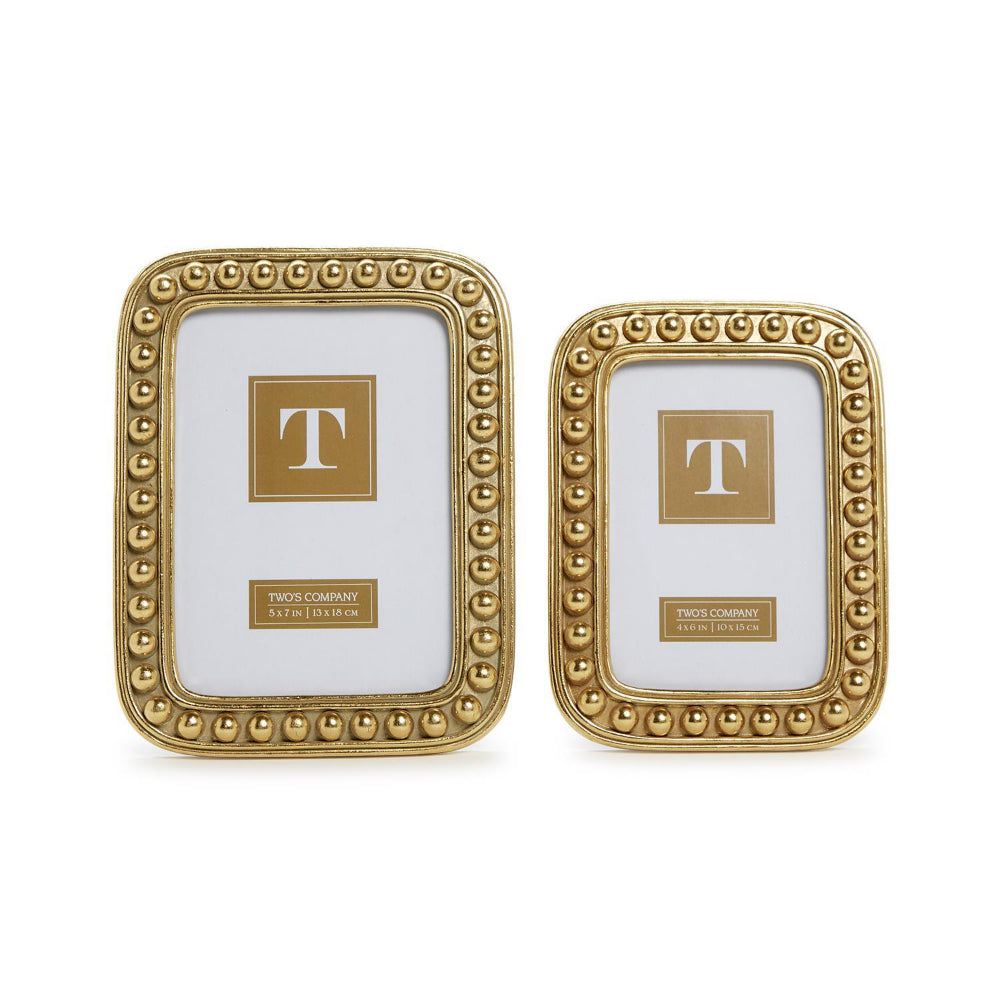 Two gold picture frames with decorative border in sizes: 4x6 & 5x7 on a white background.