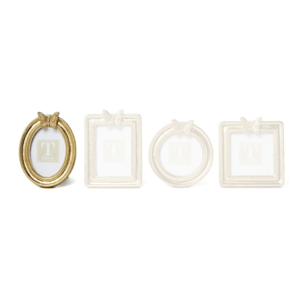 Oval gold picture frame with a  decorative butterfly on top on a white background.