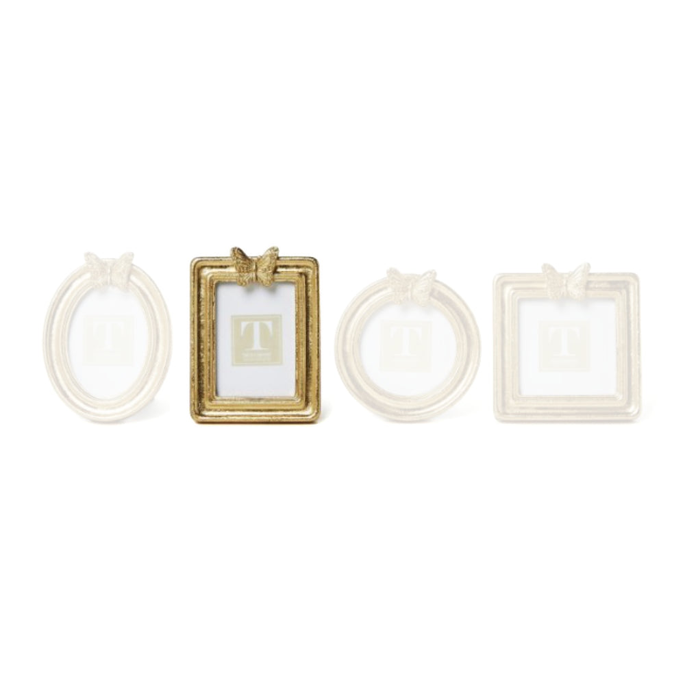 Vertical Rectangled gold picture frame with a  decorative butterfly on top on a white background.