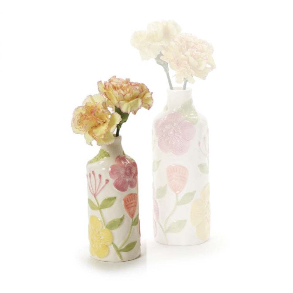 Two small ceramic vases with a white base and pastel floral patterns, one holding pale yellow flowers and the other holding pale pink flowers, on a white background.