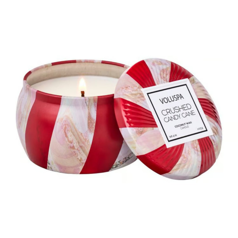Scented candle with a red and white striped design, featuring the brand 'VOLUSPA'.