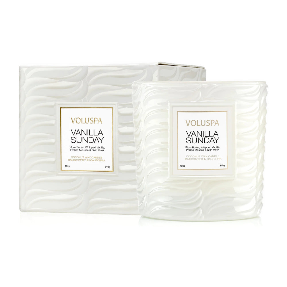 Two VOLUSPA Vanilla Sunday scented candles in textured white glass jars with matching white packaging boxes, shown on a clean white background.