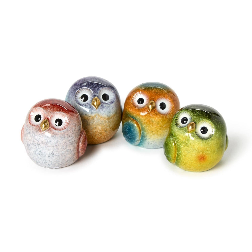 Four small ceramic owl figurines in assorted earthy multicolor glazes, arranged on a plain white background.