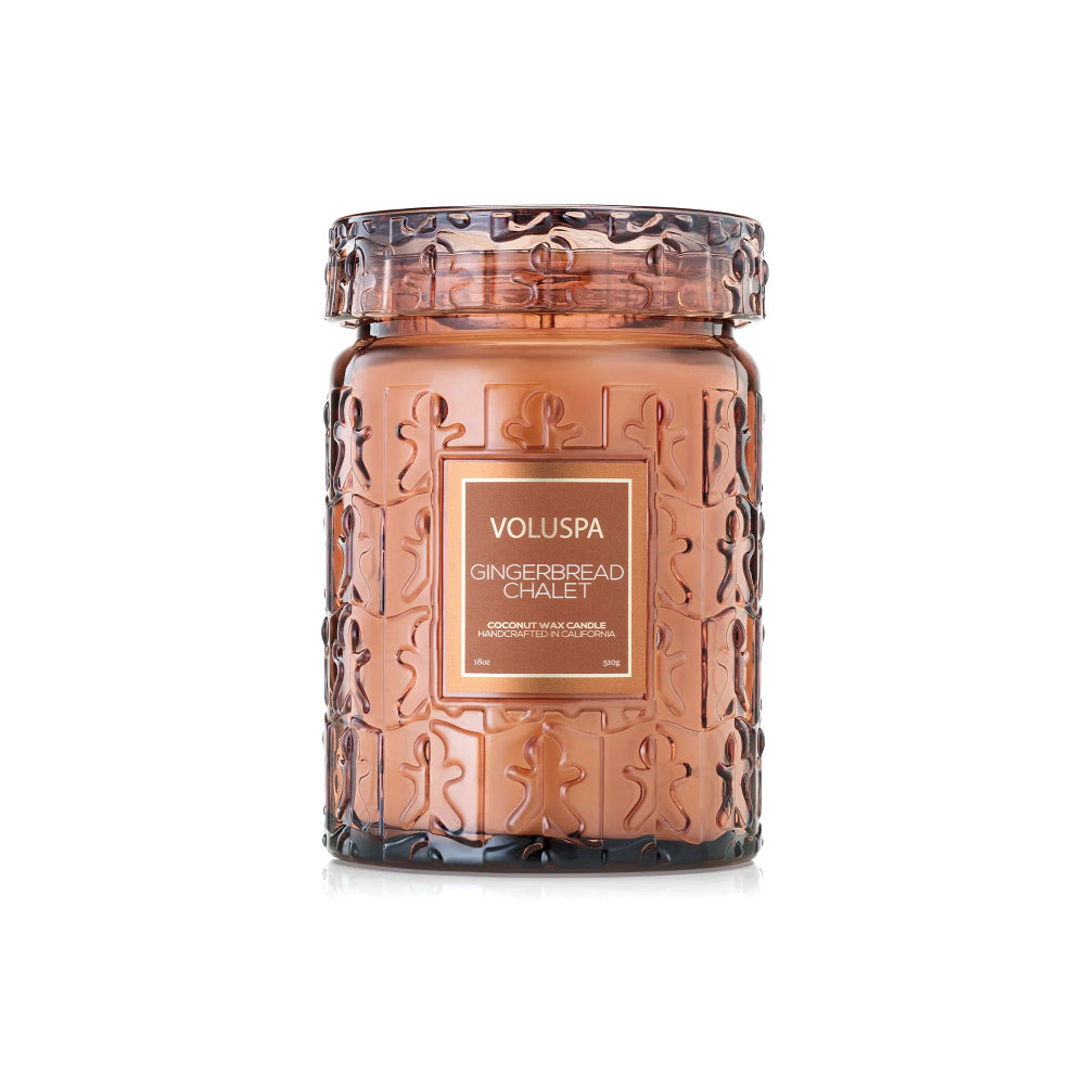 A Voluspa Gingerbread Chalet scented candle in a textured amber glass jar with a matching lid, set against a plain white background.