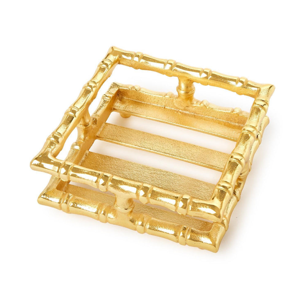 Gold bamboo napkin holder on a white backround.