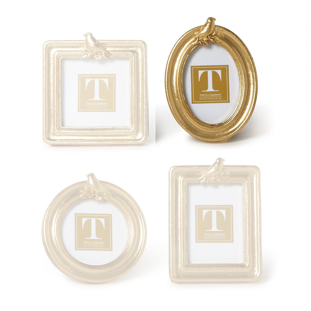 Oval gold picture frame with a gold bird on the top  a white background.