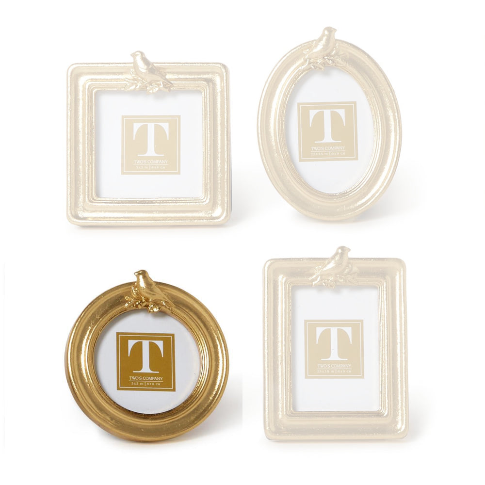 Round gold picture frame with a gold bird on the top  a white background.