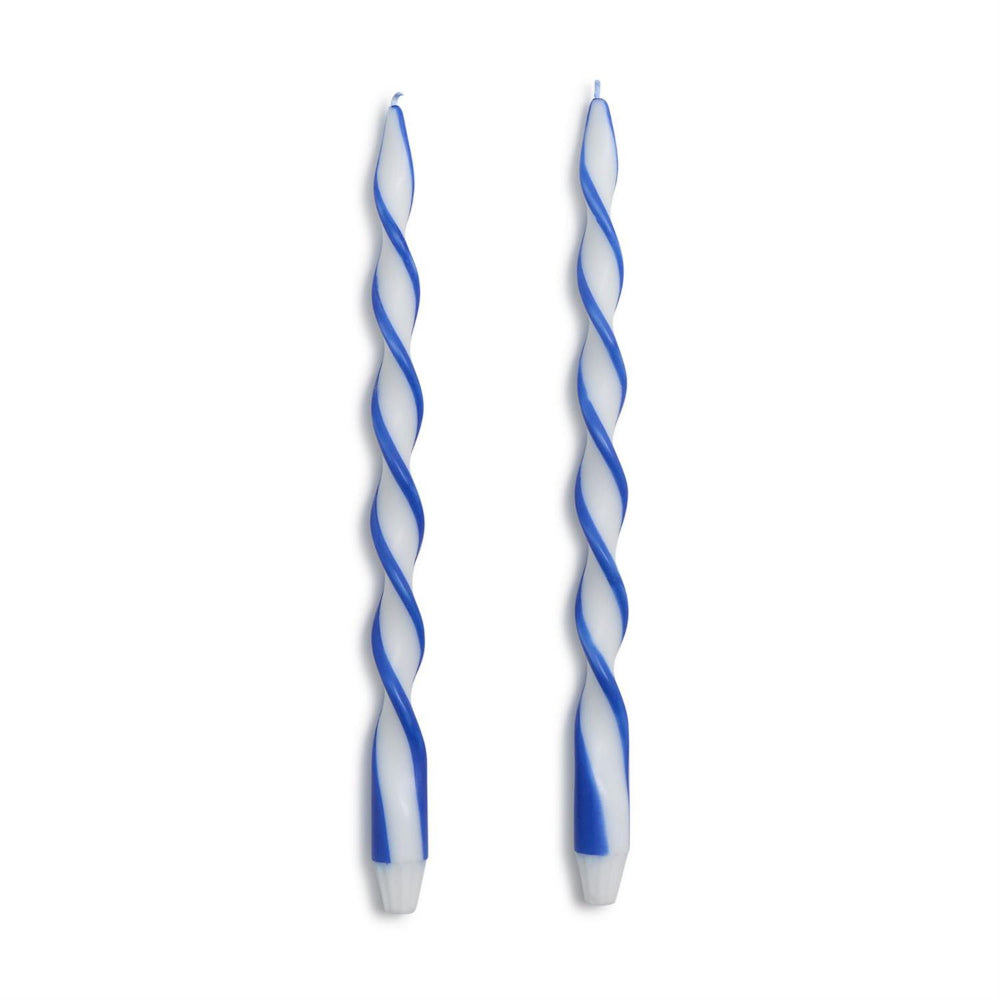 Two spiral twist candles in blue and white, standing vertically against a plain white background.