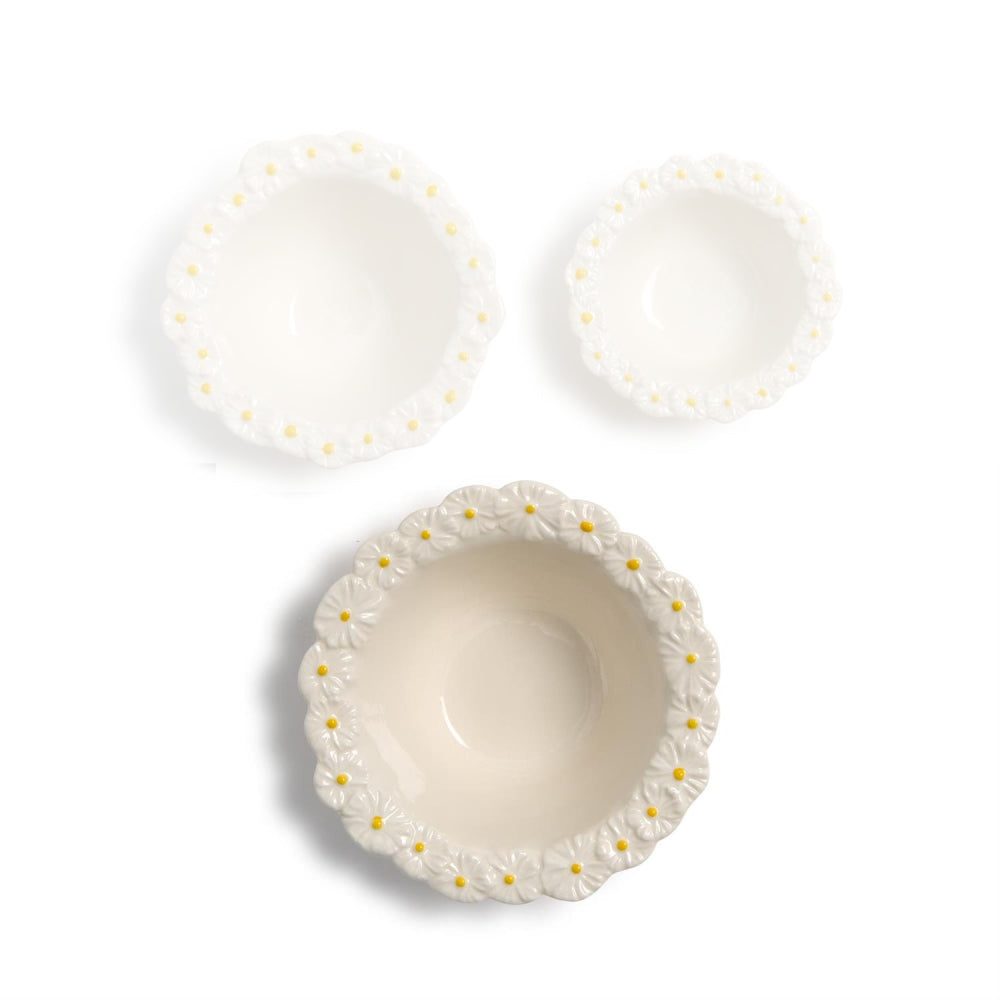 Large ceramic bowl with decorative daisy flower rims on a white background.