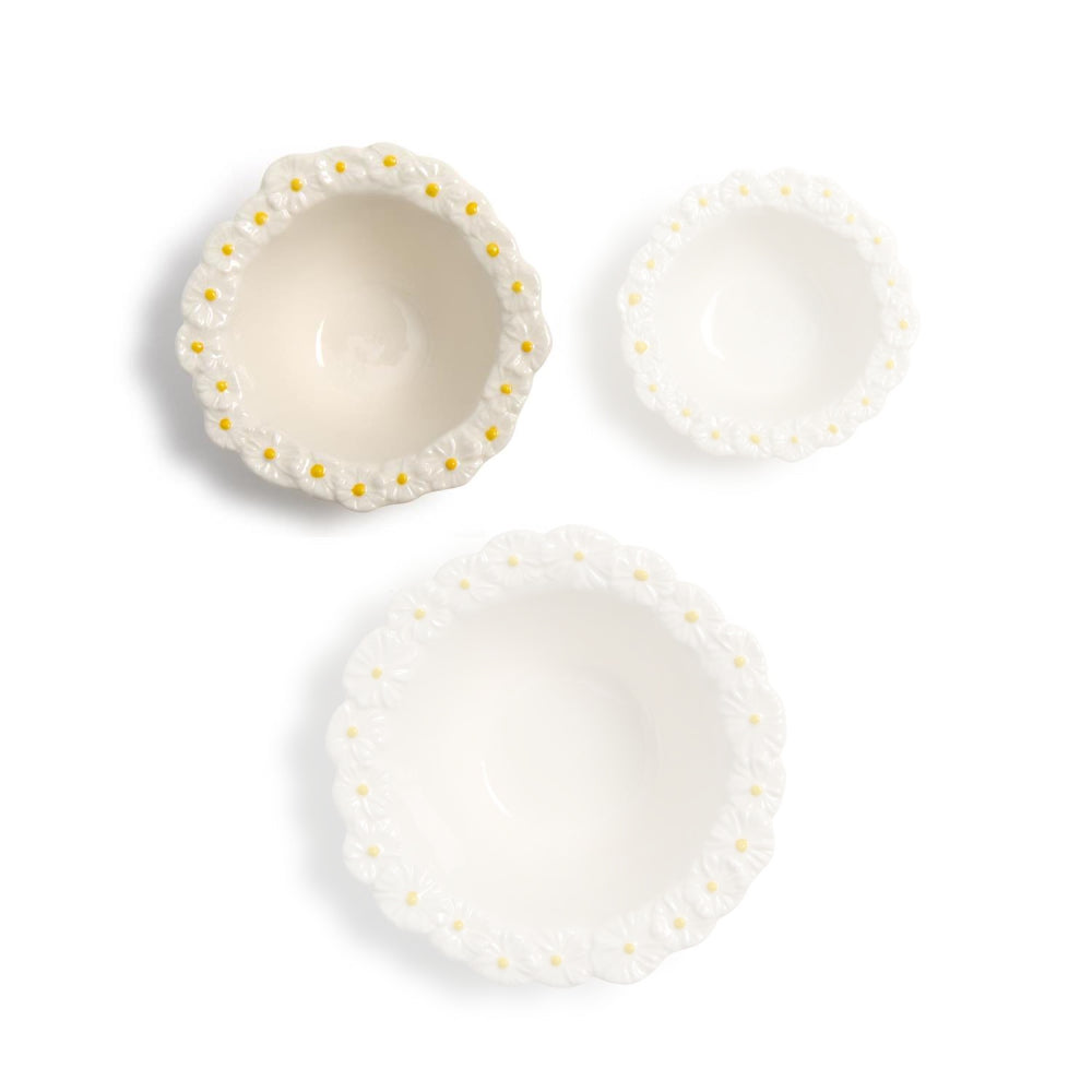 Medium ceramic bowl with decorative daisy flower rims on a white background.