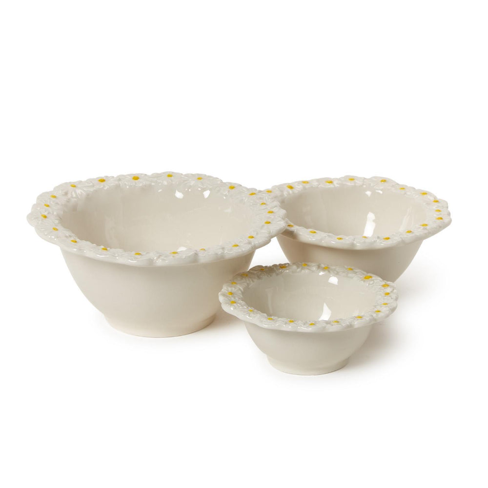 A side photo of three small, medium & large ceramic bowls with decorative daisy flower rims on a white background.
