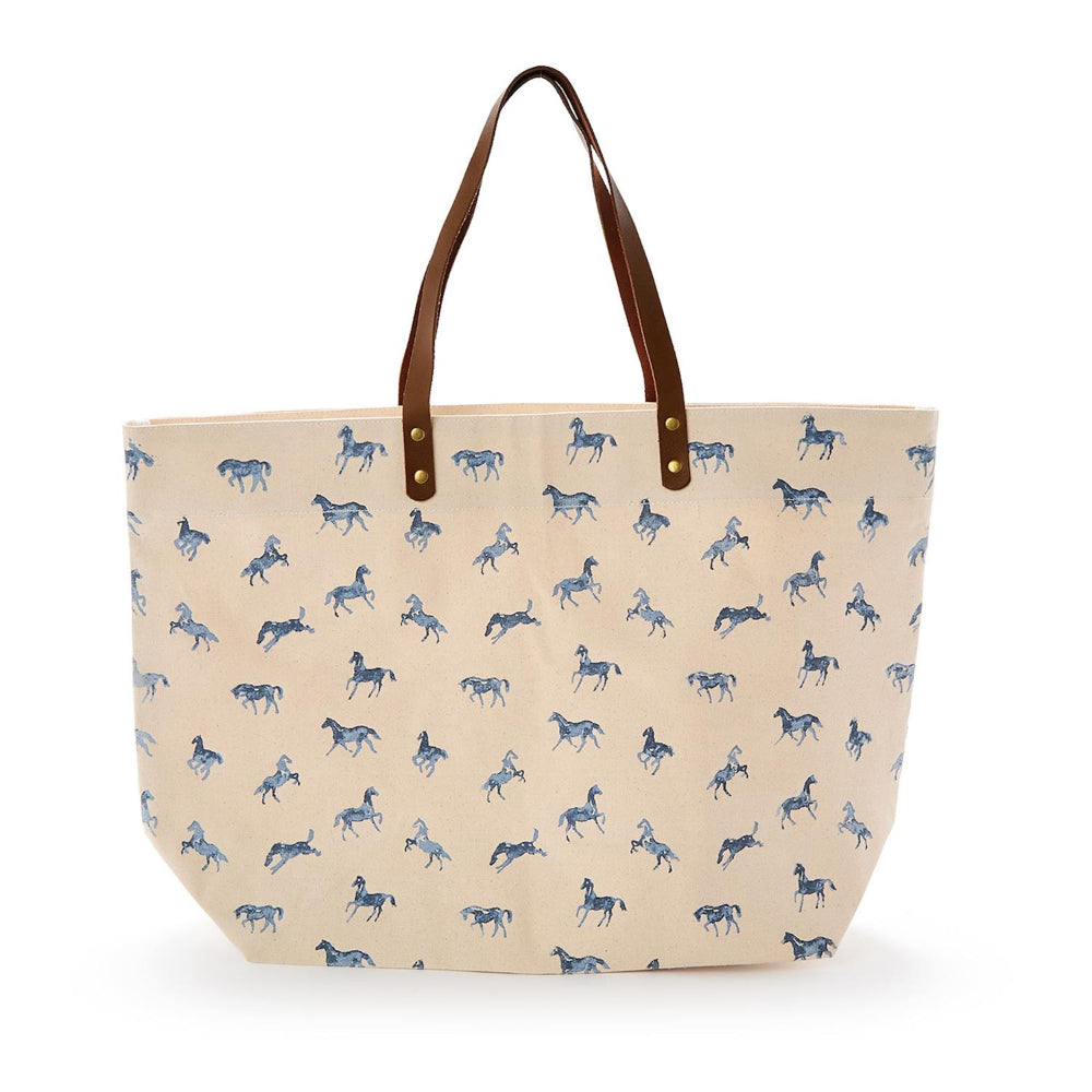 Beige tote bag with blue horse pattern and brown handles on a white background.