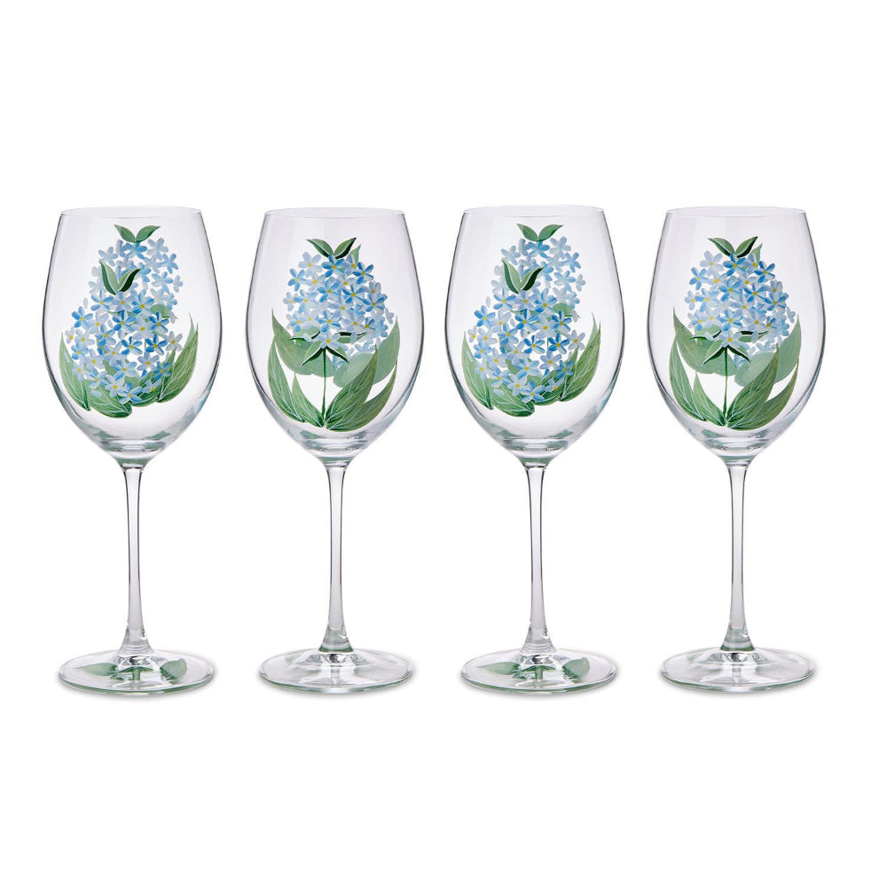 Four wine glasses with floral designs on a white background.