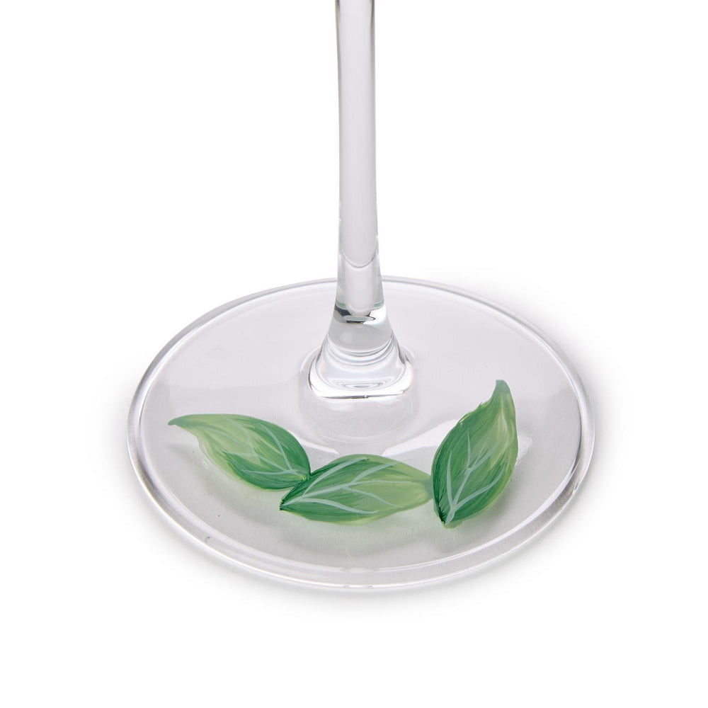 Wine glass with green leaf design on a white background (bottom of wine glass).