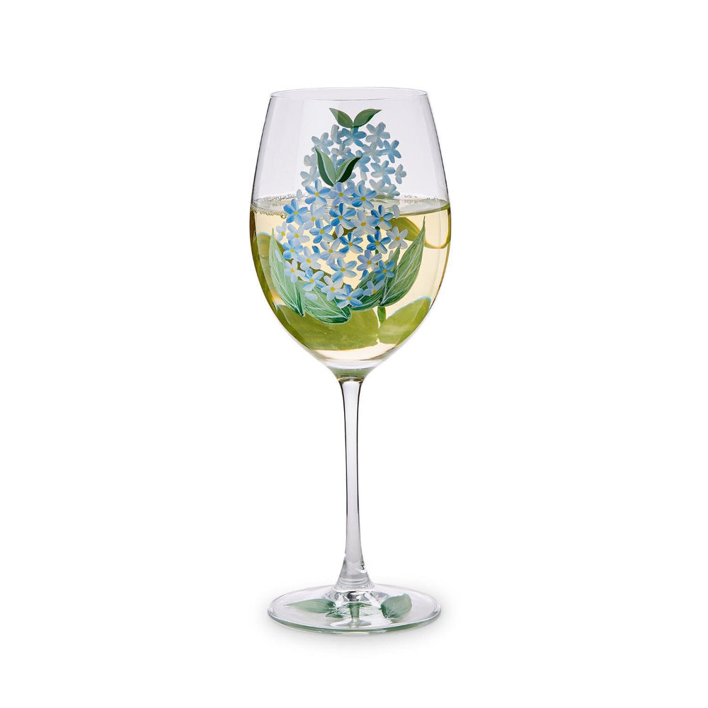 A single wine glass with floral design on a white background.