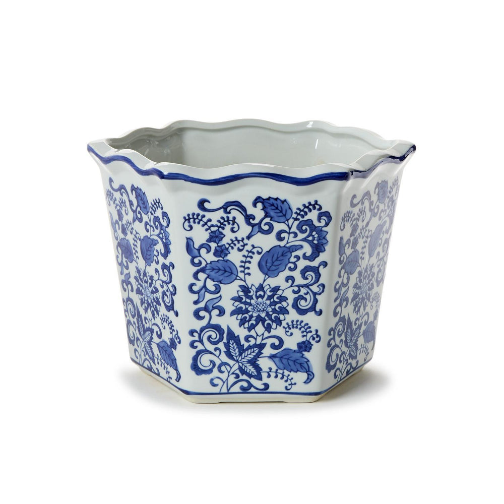 A large hexagonal ceramic planter with a scalloped rim, decorated in a classic blue and white floral pattern, set against a plain white background.