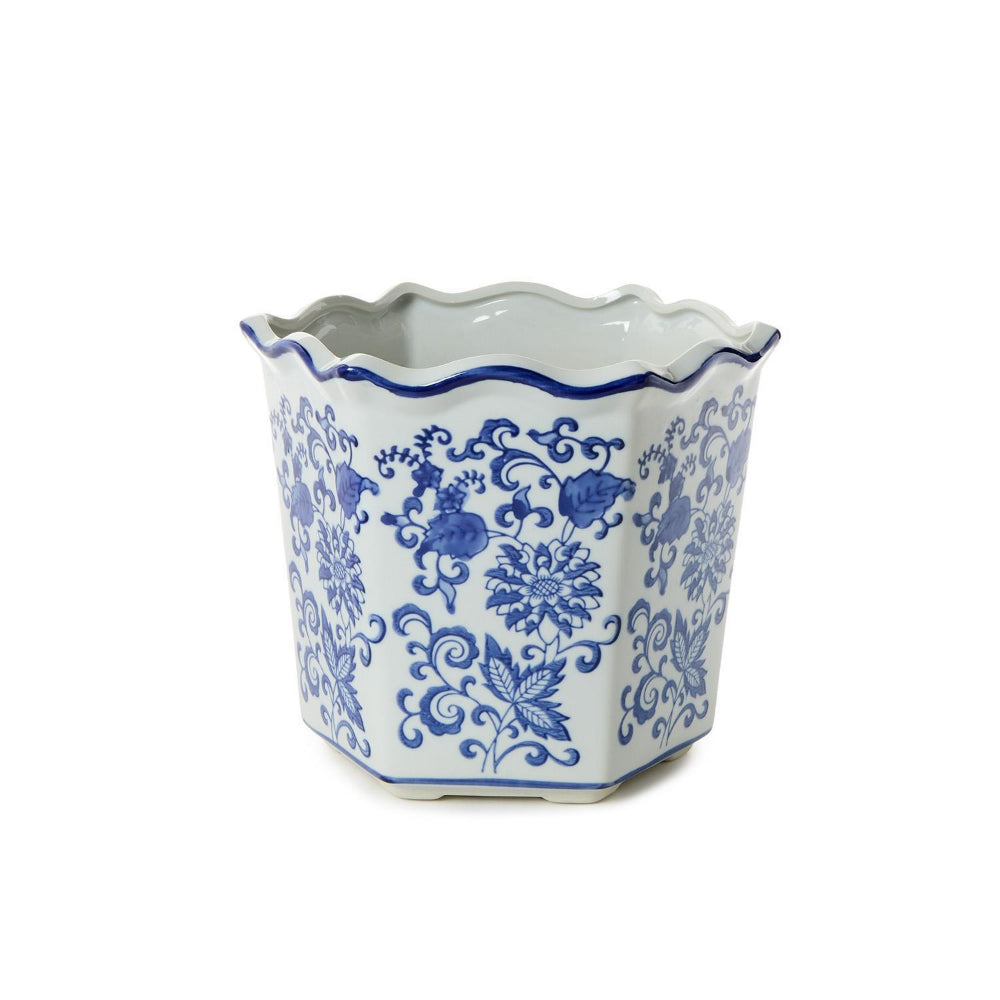 A medium hexagonal ceramic planter with a scalloped rim, decorated in a classic blue and white floral pattern, set against a plain white background.