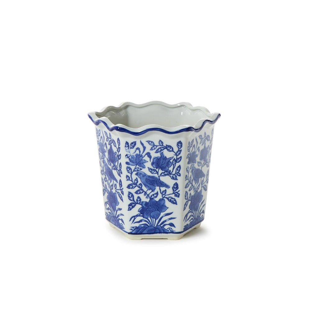 A small hexagonal ceramic planter with a scalloped rim, decorated in a classic blue and white floral pattern, set against a plain white background.